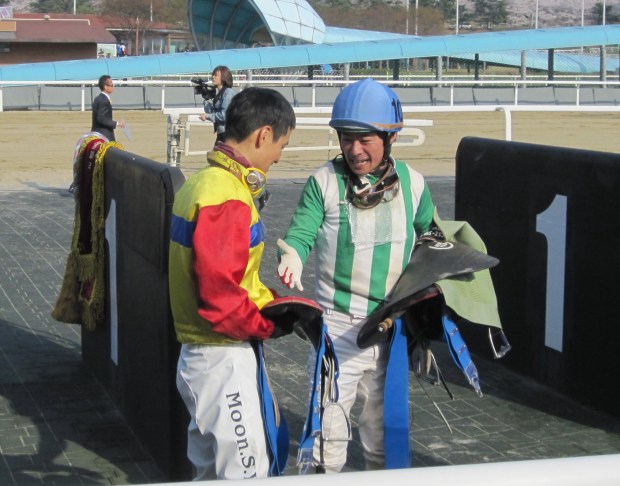 Japanese jockey Yukio Abe (right), who rode New And Best to a shock 2nd place, congratulates winner Moon Se Young