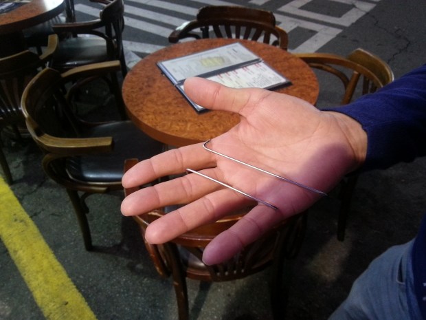 Fujii displays the pins that had just been taken from his shoulder